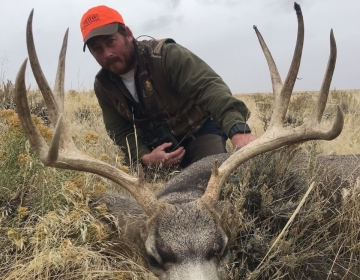 Wyoming non resident hunter with his 5x5 mule deer